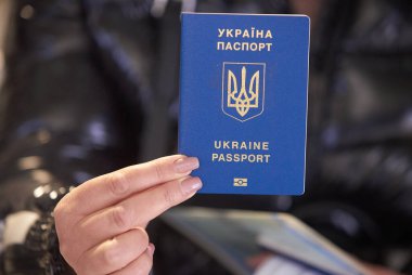 Bucharest, Romania. 13th Mar, 2023: An Ukrainian refugee woman shows her passport to the camera at the UNHCR integrated center for Ukrainian refugees. This image is for editorial use only. clipart