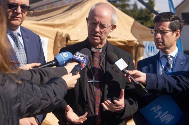 Bucharest, Romania. 13th Mar, 2023: Justin Welby (C) Archbishop of Canterbury speaks to the press during the visit UNHCR integrated center for Ukrainian refugees due to the Russian invasion of Ukraine