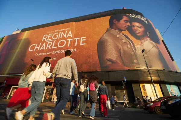 stock image Bucharest, Romania. 6th May, 2023: Extra large banner advertising Queen Charlotte: A Bridgerton Story, Tv Mini Series, is displayed on the Unirea Shopping Center, the crowdest place in downtown Bucharest. 