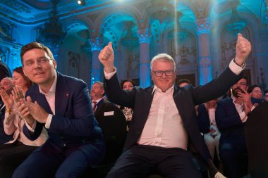 Bucharest, Romania. 6th Apr, 2024: Nicolas Schmit (R), PES lead candidate for the EU elections, celebrate next to Romanian MEP Victor Negrescu (L), PES Vice-President, at the end of the PES conference clipart