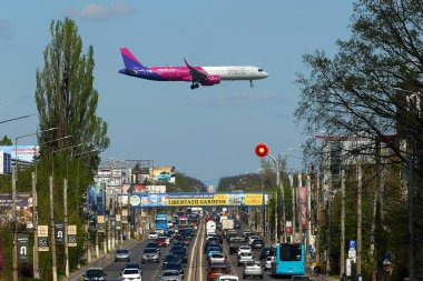 Otopeni, Romania. 8th Apr, 2024: Flight Paris to Bucharest, W43052, of the low cost airline Wizz Air lands at Bucharest Henri Coanda International Airport (AIHCB), over the National Road no. 1 in Otopeni, 16.5 km north of Bucharest. Romania and Bul clipart