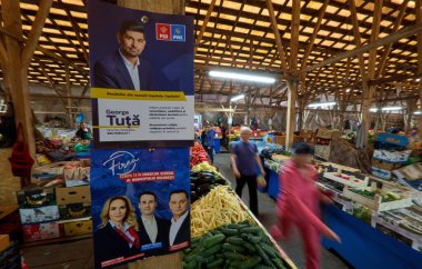 Bucharest, Romania. 27th May, 2024: Electoral flyers of the Social Democratic Party (PSD) and the National Liberal Party (PNL) on a pole during an election campaign action at the 