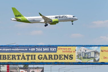 Otopeni, Romania. 9th July, 2024: airBaltic flight Zurich to Bucharest lands at Bucharest Henri Coanda International Airport (AIHCB), over the National Road no. 1 in Otopeni, 16.5 km north of Bucharest. clipart