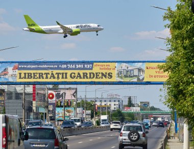 Otopeni, Romania. 9th July, 2024: airBaltic flight Zurich to Bucharest lands at Bucharest Henri Coanda International Airport (AIHCB), over the National Road no. 1 in Otopeni, 16.5 km north of Bucharest. clipart