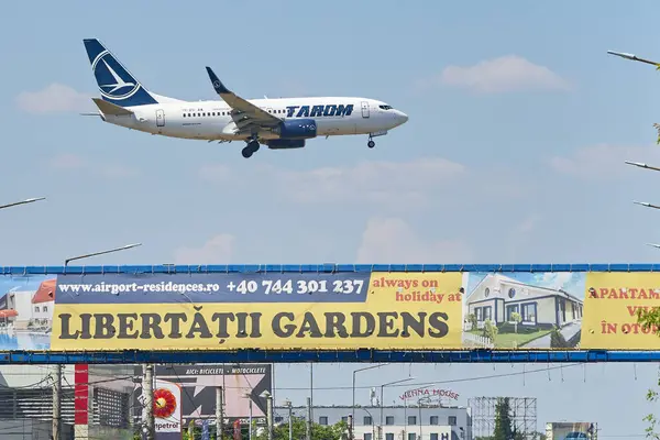 stock image Otopeni, Romania. 9th July, 2024: Tarom flight Frankfurt to Bucharest lands at Bucharest Henri Coanda International Airport (AIHCB), over the National Road no. 1 in Otopeni, 16.5 km north of Bucharest.