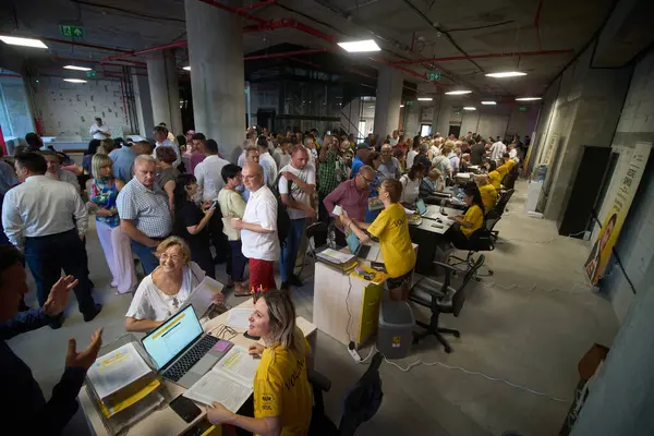 stock image Bucharest, Romania. 22nd July, 2024: Volunteers help people fill out 