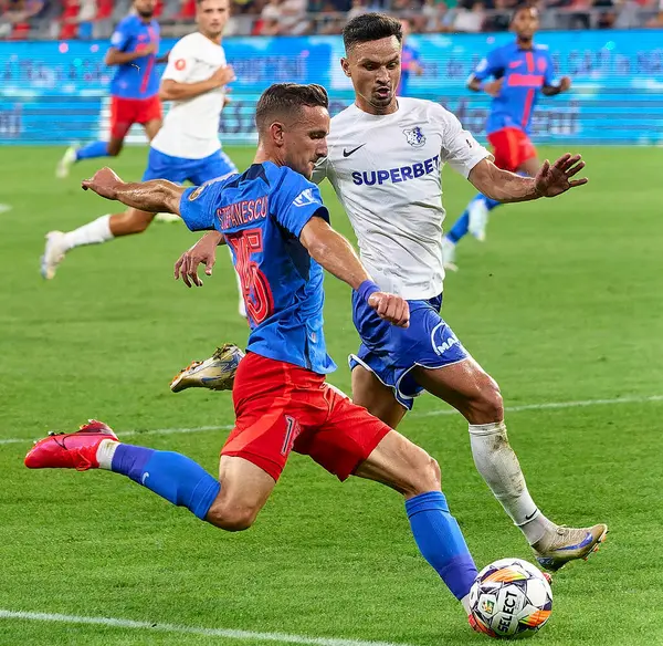 stock image Bucharest, Romania. 9th Aug, 2024: Marius Stefanescu (L) of FCSB attacks with the ball Farul defender Cristian Ganea (R) during the football match between FCSB and FCV Farul Constanta in the 5th round of Superliga, the first league of the Romanian 20