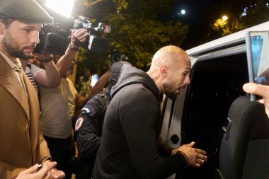 Bucharest, Romania. 21st Aug, 2024: Andrew Tate (R) followed by his brother Tristan Tate (L) leave the Directorate for Investigating Organized Crime and Terrorism DIICOT in handcuffs clipart