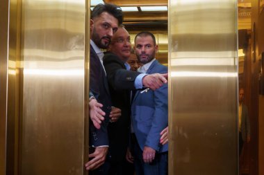 Bucharest, Romania. 29th Aug, 2024: Nicolae Ciuca (C), the president of the National Liberal Party (PNL), holds the elevator door for PNL general secretary Lucian Bode (not in picture) as leaves after the meeting of the National Political Bureau of t clipart