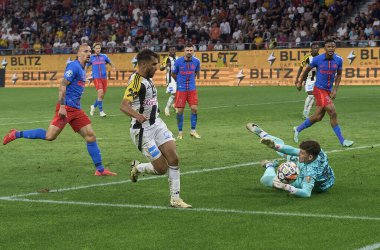 Bucharest, Romania. 29th Aug, 2024: Stefan Tarnovanu, FCSB goalkeeper, saves a ball against Adil Taoui during the UEFA Europa League, Play-offs 2nd leg football match between FCSB and LASK, at Steaua Stadium, in Bucharest. clipart