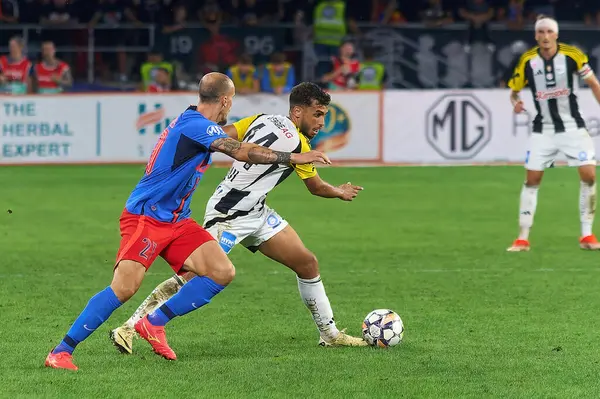 stock image Bucharest, Romania. 29th Aug, 2024: Adil Taoui (R), of LASK, fight for the ball with Vlad Chiriches (L) of FCSB during the UEFA Europa League, Play-offs 2nd leg football match between FCSB and LASK, at Steaua Stadium, in Bucharest.