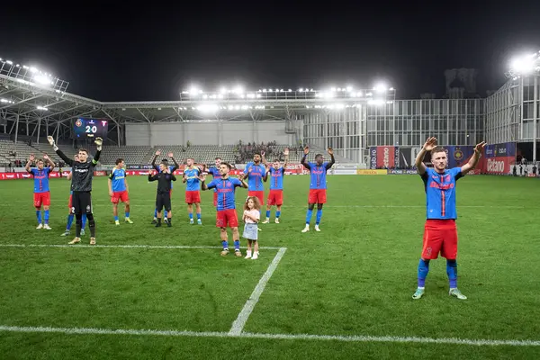 stock image Bucharest, Romania. 1st Sep, 2024: Alexandru Baluta with his daughter and FCSB teammates greets the fans at the end of the football match between FCSB and UTA Arad in the 8th round of Superliga, the first league of the Romanian 2024-2025 football cha