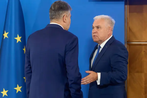 stock image Bucharest, Romania. 4th Sep, 2024: Marcel Ciolacu (L), the Prime Minister of Romania, and Angel Tilvar (R), the Romanian Minister of Defense, speak during the government meeting at the Victoria Palace, the Romanian Government headquarters.