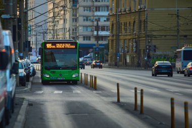 Bucharest, Romania - September 04, 2024: A public transport bus Mercedes Citaro Hybrid is driven in traffic on a boulevard in Bucharest. clipart