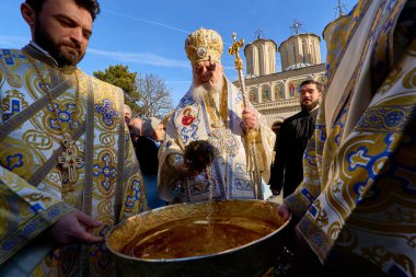 Bucharest, Romania. 6th Jan, 2025: Patriarch Daniel (C) takes Great Holy Water to sprinkle on the Orthodox faithful during the Feast of Epiphany at the Patriarchal Cathedral in Bucharest. clipart