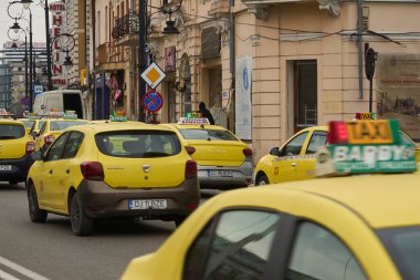 Craiova, Romanya. 28. Mar, 2025: Dolj County 'nin Craiova kentinin girişindeki Alexandru Ioan Cuza Caddesi' ndeki bir taksi durağında sarı taksiler park halinde..