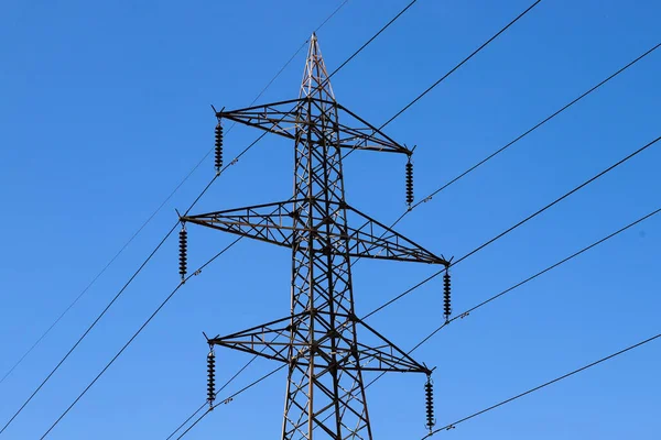 stock image A power line tower with a blue sky in the background