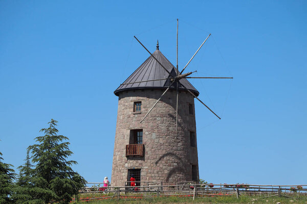 Windmill and blue sky. Photo of windmill with harvests