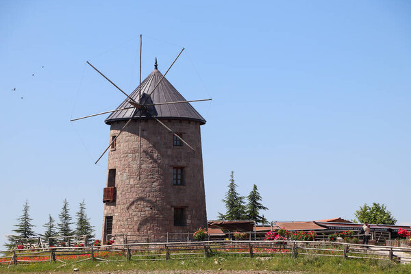 Windmill and blue sky. Photo of windmill with harvests