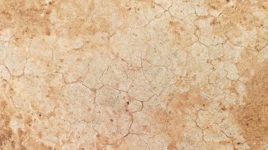 Zemin, kuraklık ve ölüm kavramına sahip arka plan veya grafik tasarımı için üst görünümde çatlaklar var..