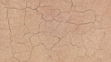 Zemin, kuraklık ve ölüm kavramına sahip arka plan veya grafik tasarımı için üst görünümde çatlaklar var..