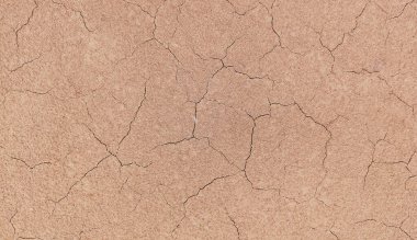 Zemin, kuraklık ve ölüm kavramına sahip arka plan veya grafik tasarımı için üst görünümde çatlaklar var..