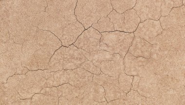 Zemin, kuraklık ve ölüm kavramına sahip arka plan veya grafik tasarımı için üst görünümde çatlaklar var..