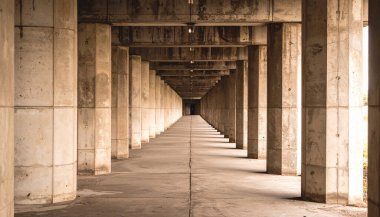 Acımasız beton sütunlar sonsuzluğa doğru çekiliyor, mükemmel odaklı tek bir düz panel 