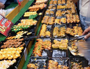 Müşteri, marketteki bir kutudan suşi alıyor..