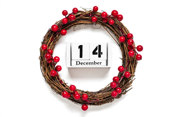 stock image Christmas wreath decorated with red berries, wooden calendar date 12 December isolated on white background Concept of Christmas preparation, atmosphere Wishes card Hand made Christmas wreath Flat lay.