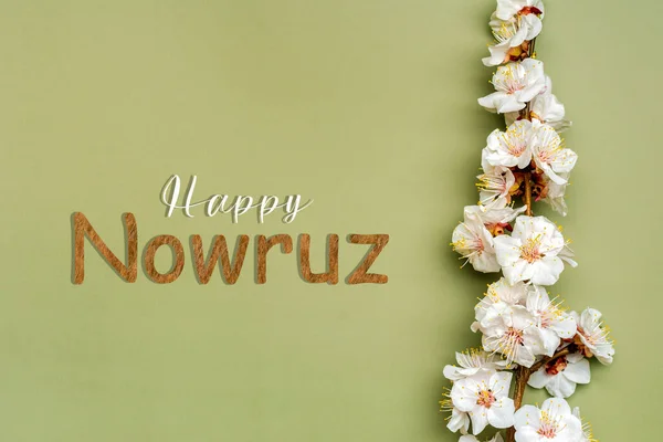 stock image Sprigs of the apricot tree with flowers Text Happy Nowruz Holiday Concept of spring came Top view Flat lay Hello march, april, may, persian new year.