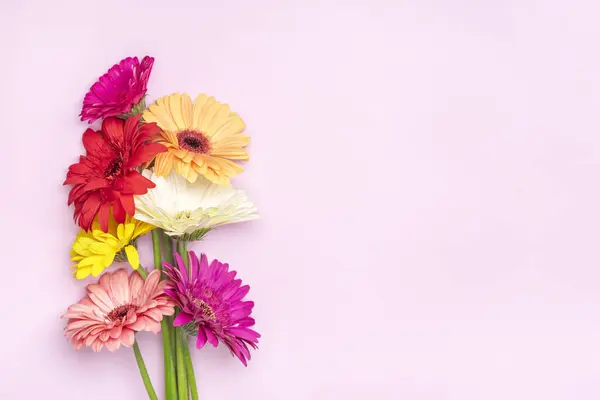Bouquet of gerberas on pink background Top view Flat lay Holiday greeting card Happy moter's day, 8 March, Valentine's day, Easter concept Copy space Mock up.