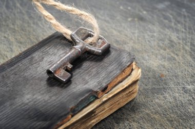 Old key on a old book, antique wood background. Real estate concept