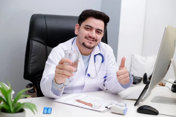 Young Doctor Sitting Chair Clinic Holding Water Glass Hand — Stock Photo, Image