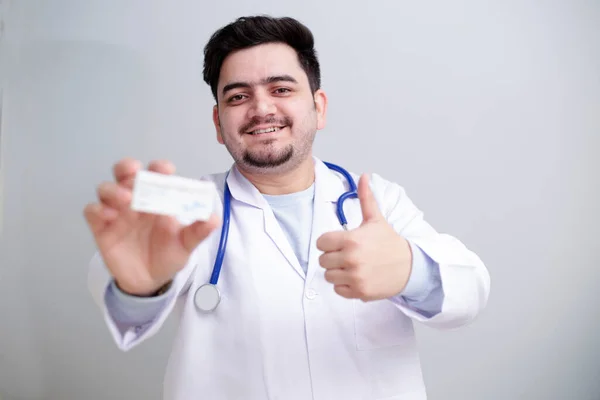Mladý Doktor Drží Jedné Ruce Léky Ukazuje Palce Nahoru — Stock fotografie