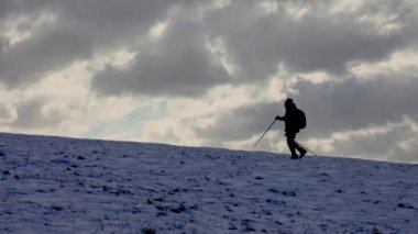 Adam kış yürüyüşünden önce koruyucu krem sürüyor. Soğuk hava ve kar fırtınasına hazırlanıyor..
