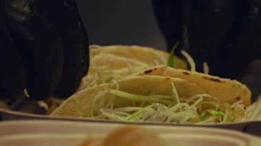 Izgara sığır eti ve taze salatanın dikkatlice paketlenip bu yakın çekim videoda teslim edilmeye hazır hale getirilmesini izleyin. Yumuşak, sulu sığır eti, yumuşak ekmeğe sarılmış, canlı, gevrek bir salata ile eşleştirilir..