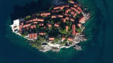 Aerial video of the famous tourist location Sveti Stefan island and picturesque Adriatic coastline near the city of Budva, Montenegro.