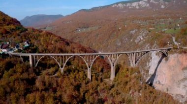 Aerial video of the magnificent Djurdjevica Bridge over Tara river canyon in the northern part of Montenegro in autumn.
