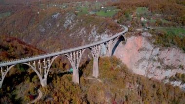 Aerial video of the magnificent Djurdjevica Bridge over Tara river canyon in the northern part of Montenegro in autumn.