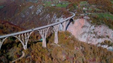 Aerial video of the magnificent Djurdjevica Bridge over Tara river canyon in the northern part of Montenegro in autumn.