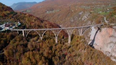 Aerial video of the magnificent Djurdjevica Bridge over Tara river canyon in the northern part of Montenegro in autumn.