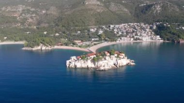 Aerial video of the famous tourist location Sveti Stefan island and picturesque Adriatic coastline near the city of Budva, Montenegro.