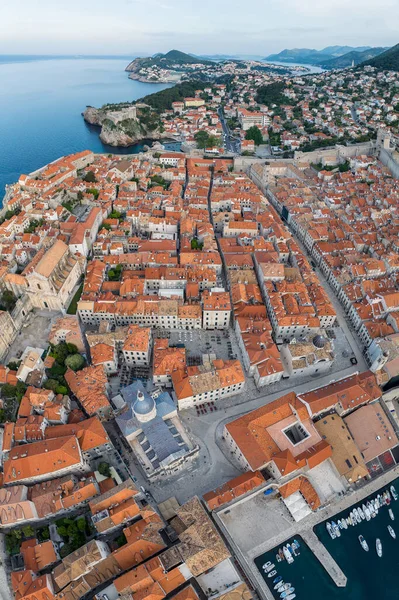 stock image Aerial panoramic view of picturesque Dubrovnik city with old town, narrow stone streets and buildings with red roofs, marina with boats on Adriatic sea coast, Croatia.