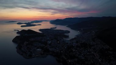 Eski kasaba Dubrovnik 'in muhteşem panoramik klibi, aydınlatılmış caddeler, binalar ve gün batımında tekneleri olan marina..