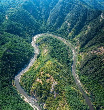 Wonderful aerial view of picturesque meander of Arda river surounded by mountain slopes of Rhodopi Mountains, Bulgaria.	 clipart