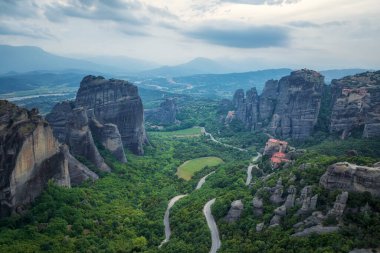 Amazing panoramic view of Meteora valley with Rousanou nunnery, St Nicholaos Anapafsas monastery and Varlaam monastery near Kastraki, Greece. clipart