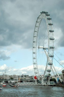 A view of the famous London Eye Ferris wheel on the banks of the Thames River, London, England. clipart