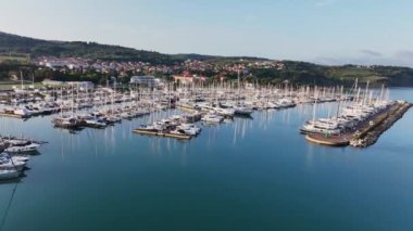 Slovenya 'nın Adriyatik Denizi kıyısındaki Izola kentinin marinasındaki tekne ve yatlar arasında panoramik hava videosu.