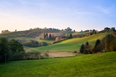 Aerial sunset landscape of the picturesque, autumn-covered hills near Maribor, close to the Austrian border in Slovenia.	 clipart